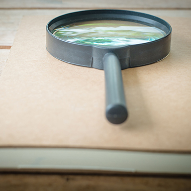 Magnifying glass on notebook