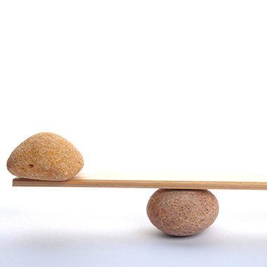 Stones on scale on white background