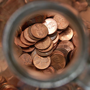 Pennies in glass jar from above