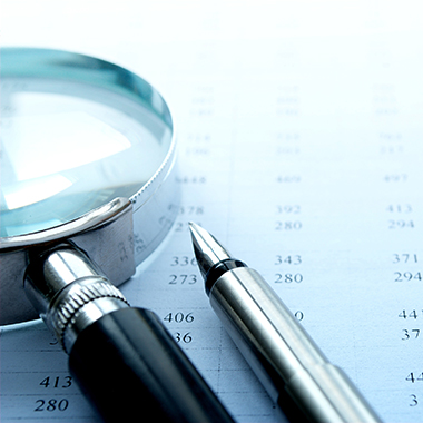 Spreadsheet and Magnifying Glass