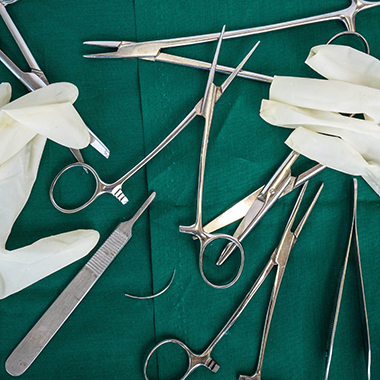 Surgical Instruments Arranged on Green Background