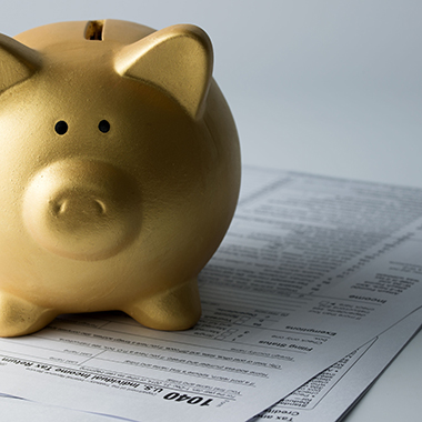 Golden Piggy Bank on Income Tax Form