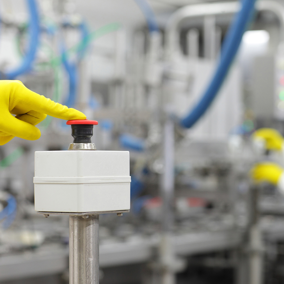 Hand in Yellow Glove Pressing Button Starting Industrial Process