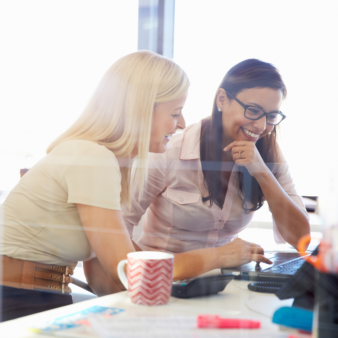Two Women Working Together at Desk