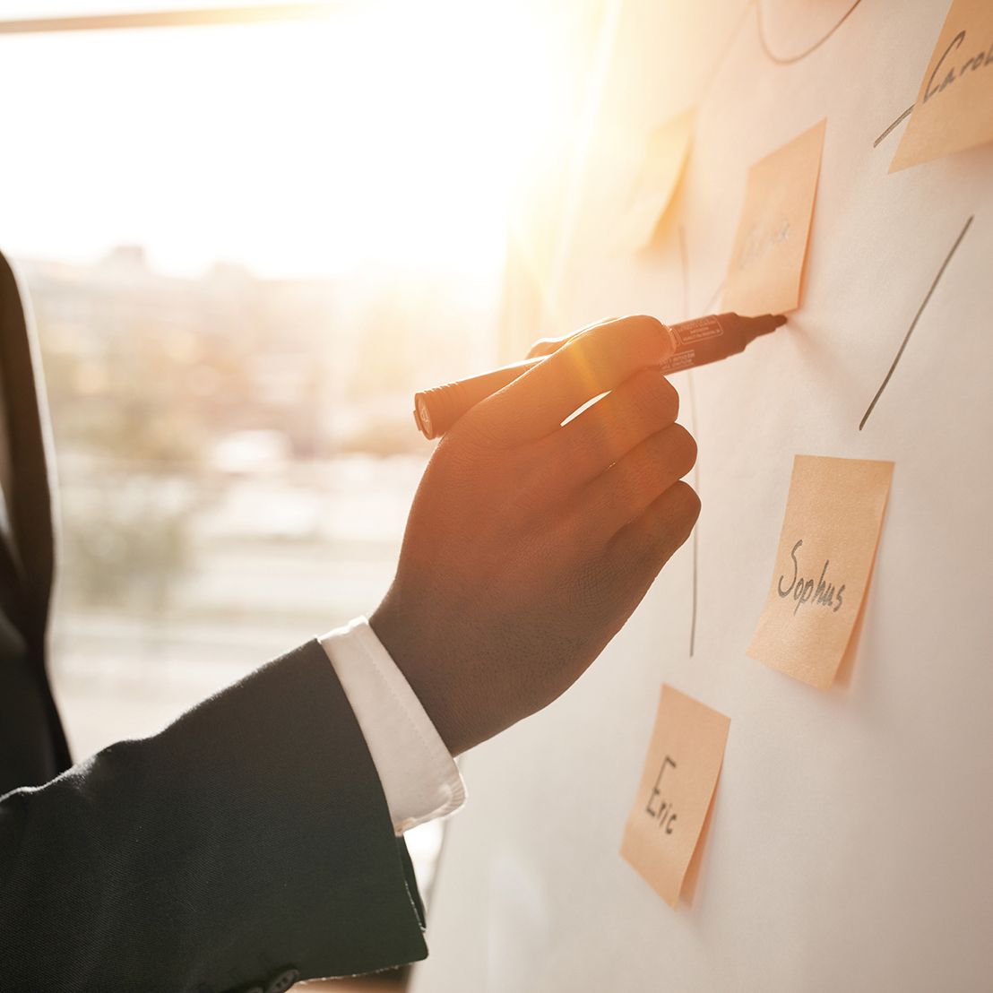 Professional Using Expo Market to Write on Sticky Notes and White Board