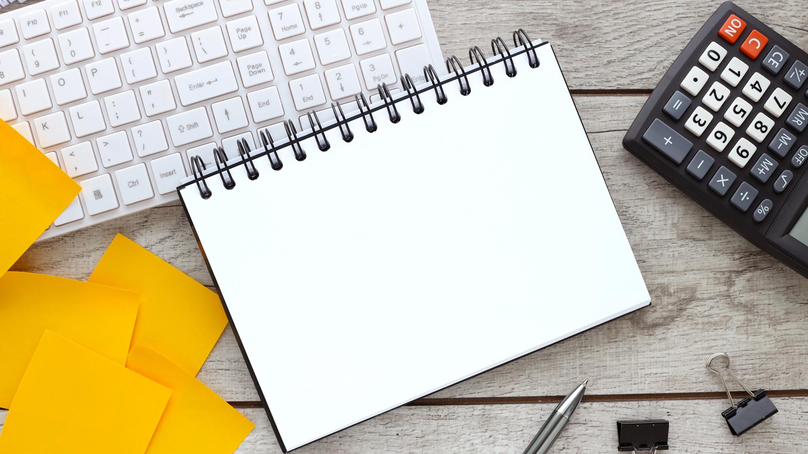 Blank open notepad on wood table