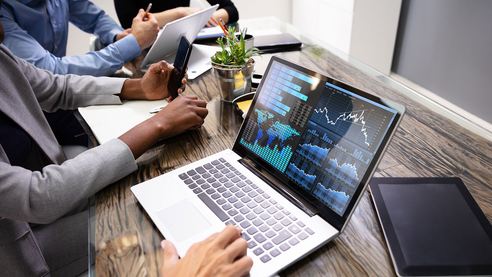 Group Of Businesspeople Examining Graph On