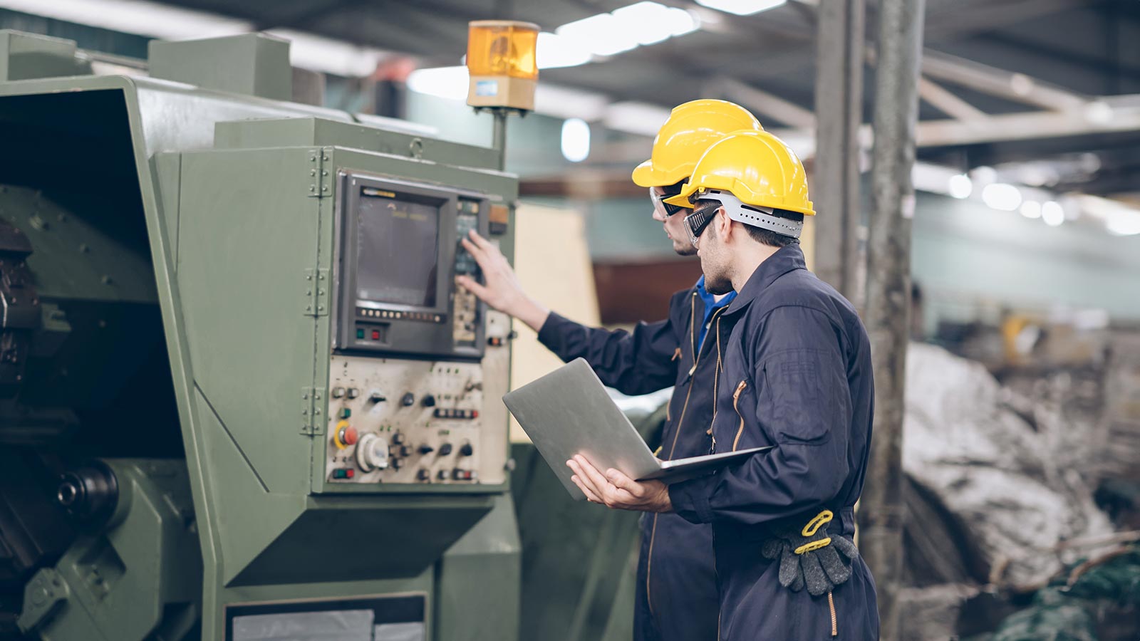 Two technician Mechanic checking on Machine in factory