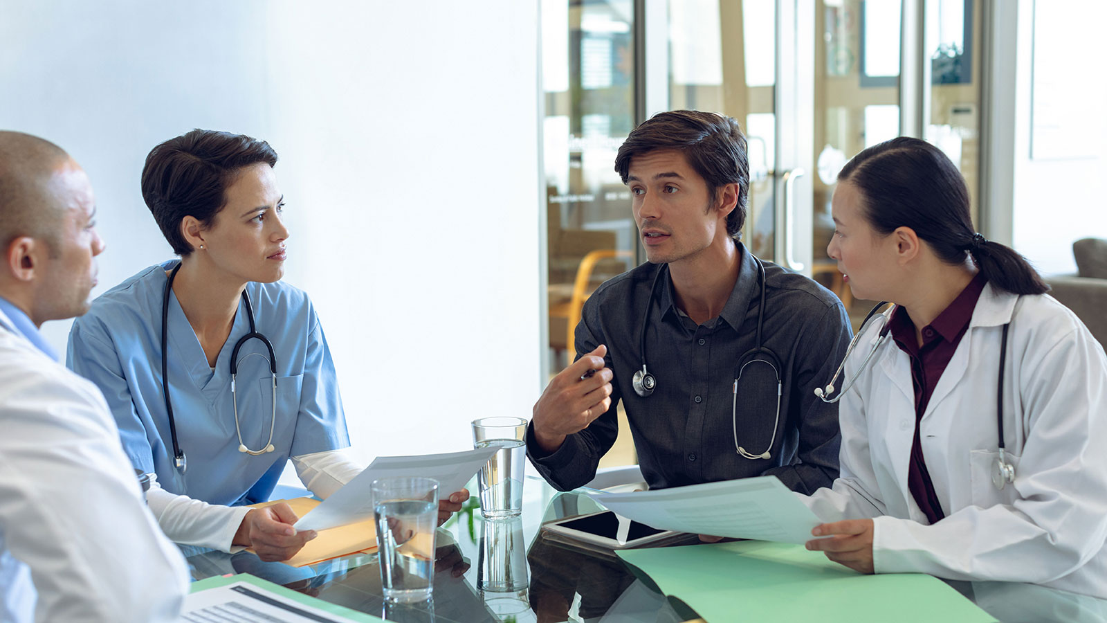 Medical-team-discussing-with-each-other-at-the-table