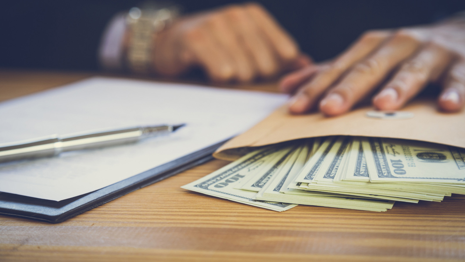 Image of an accountant with money and a notebook