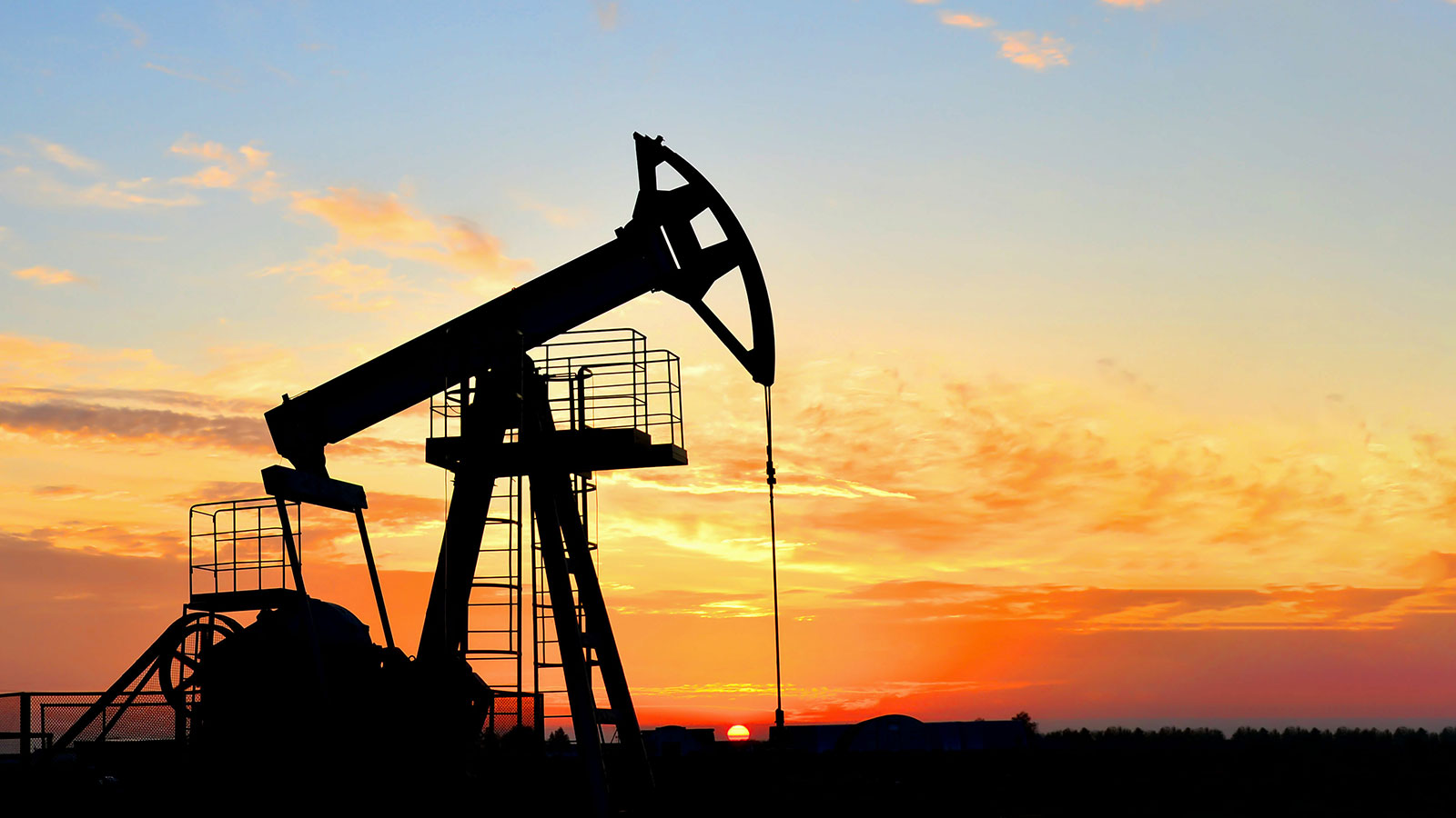 Oil drilling derricks at desert oilfield. Crude oil production from the ground