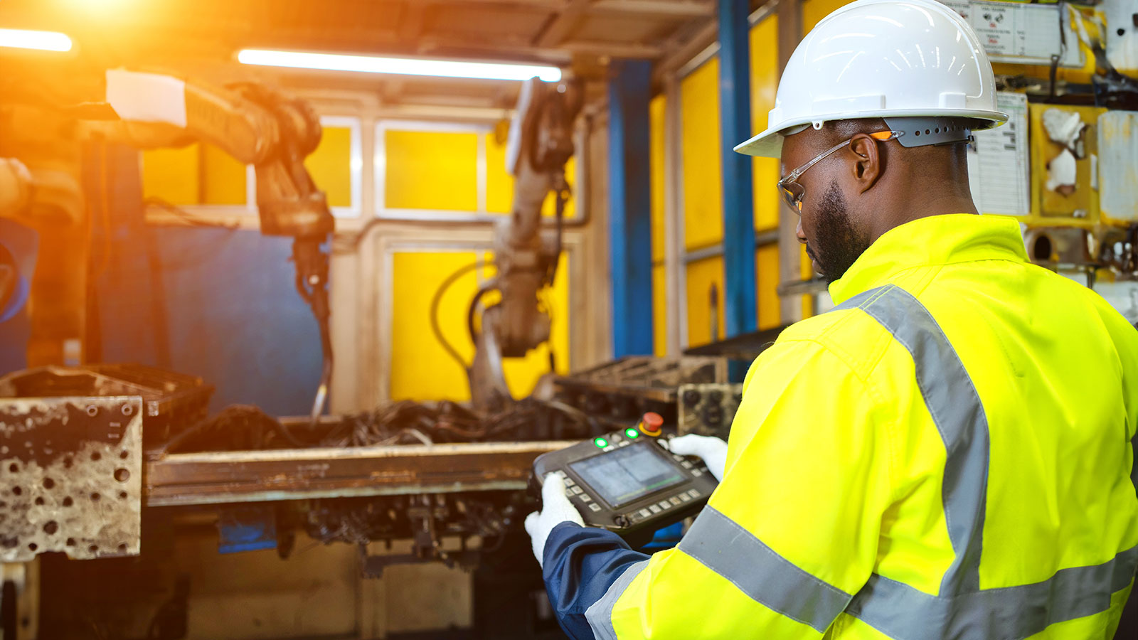 Engineer check and control automation robot arms.