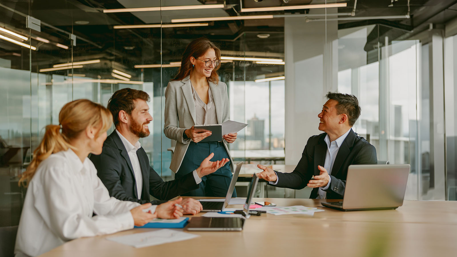 A collaborative business meeting involving professionals who are actively engaged in discussion and presentation
