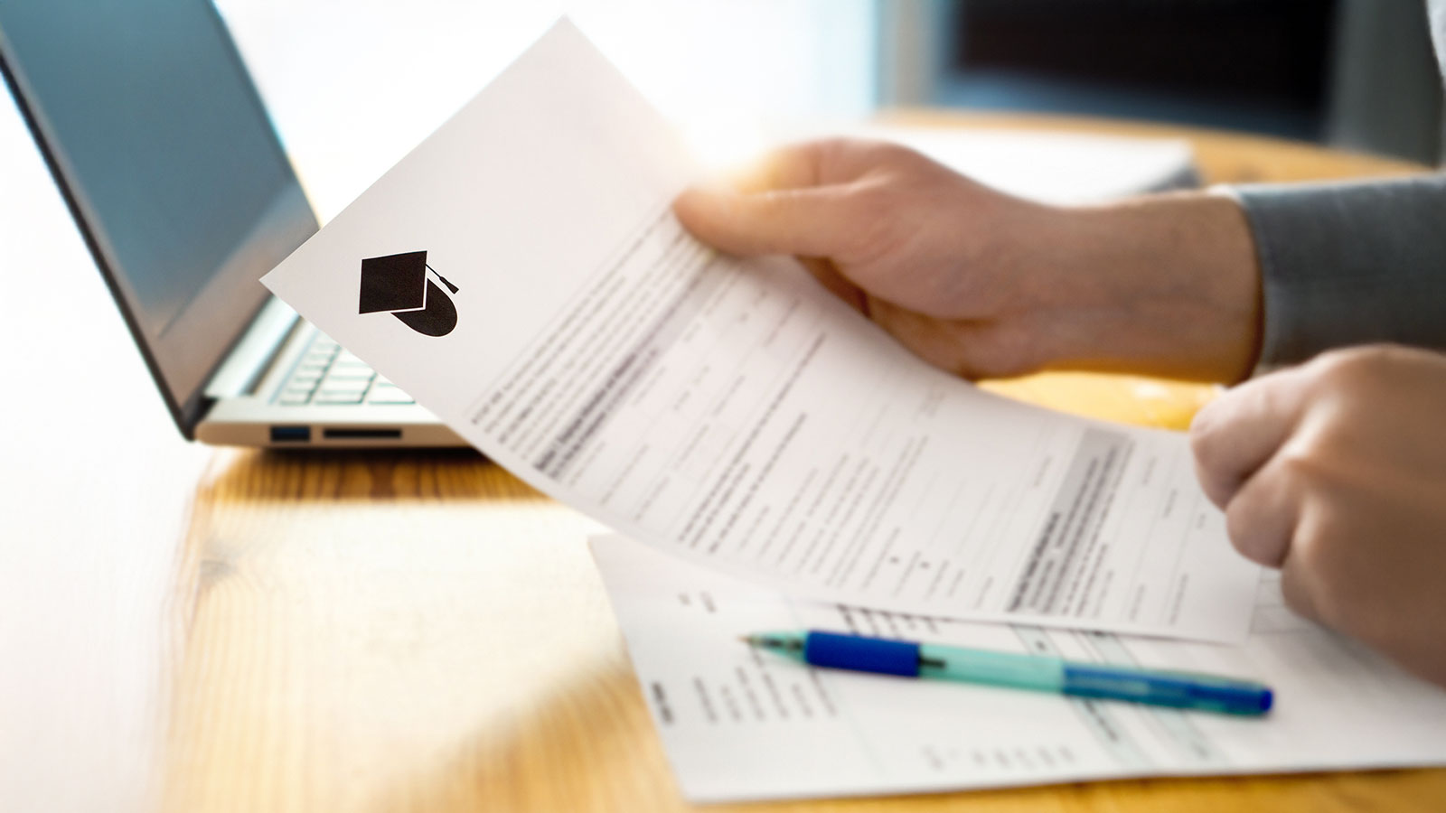 Man reading college or university application or document from school