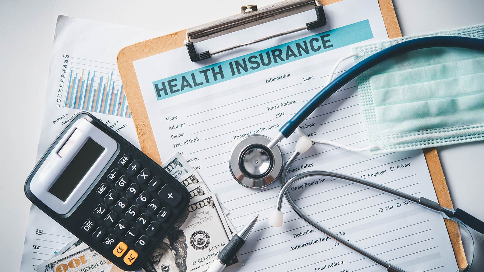 Stethoscope and calculator placed on health insurance documents