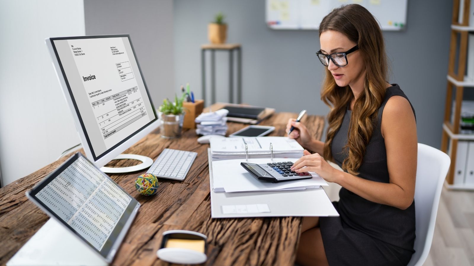 Accountant Calculating Invoice At Desk