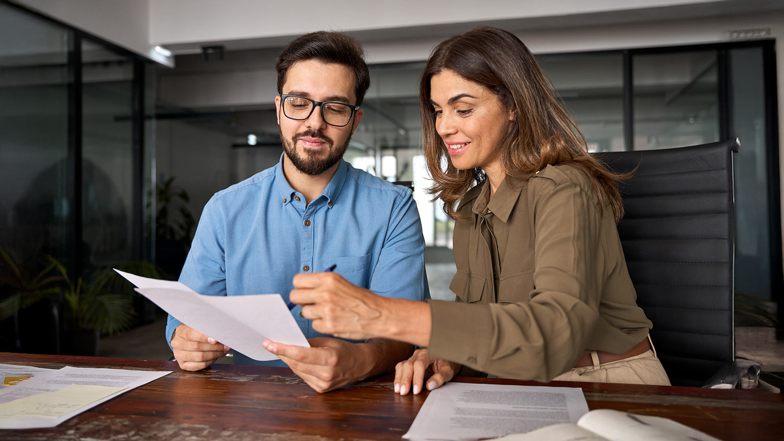 Smiling female financial advisor, attorney lawyer or bank manager consulting client