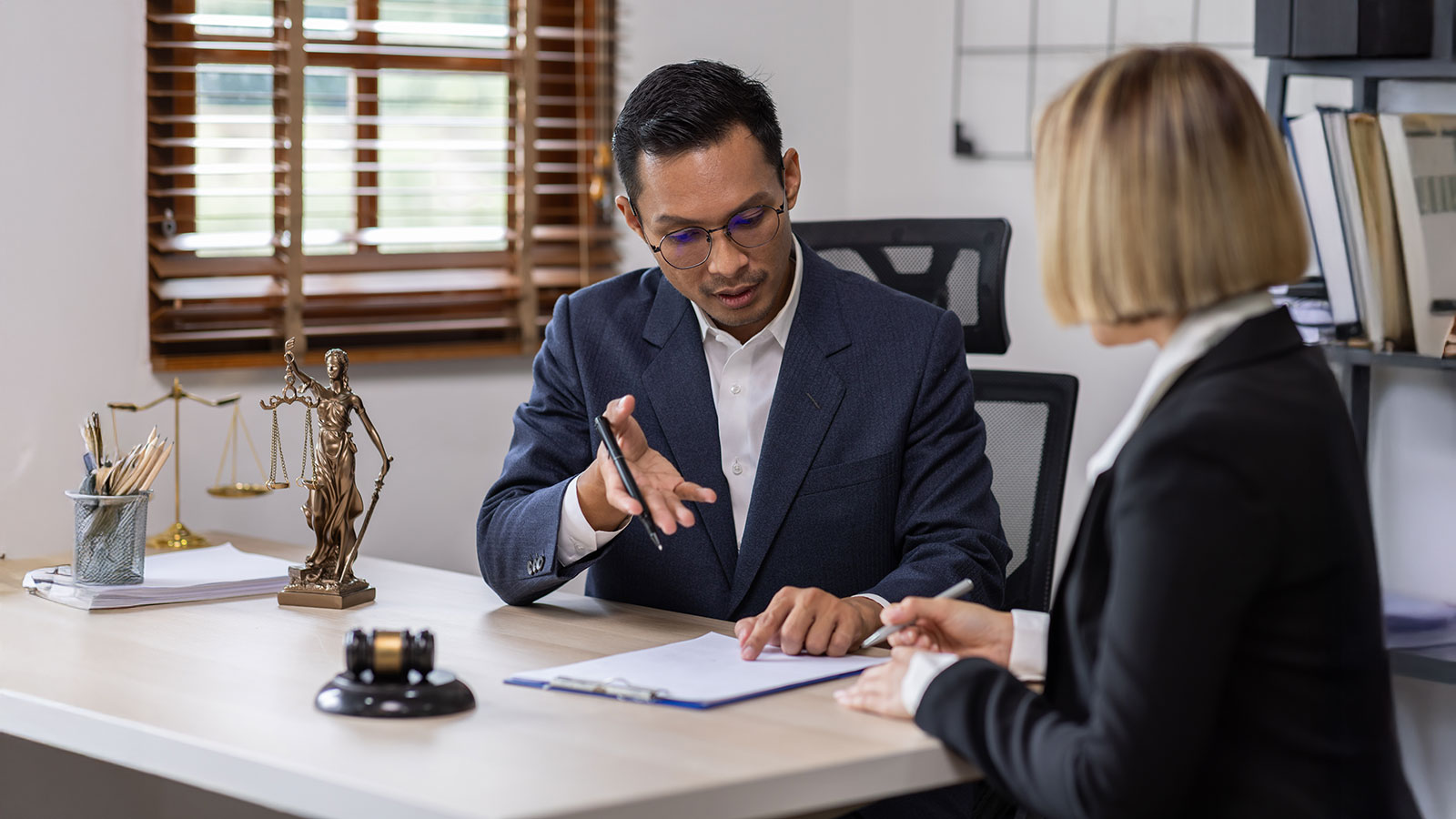 Businessman and lawyer discuss the contract document.