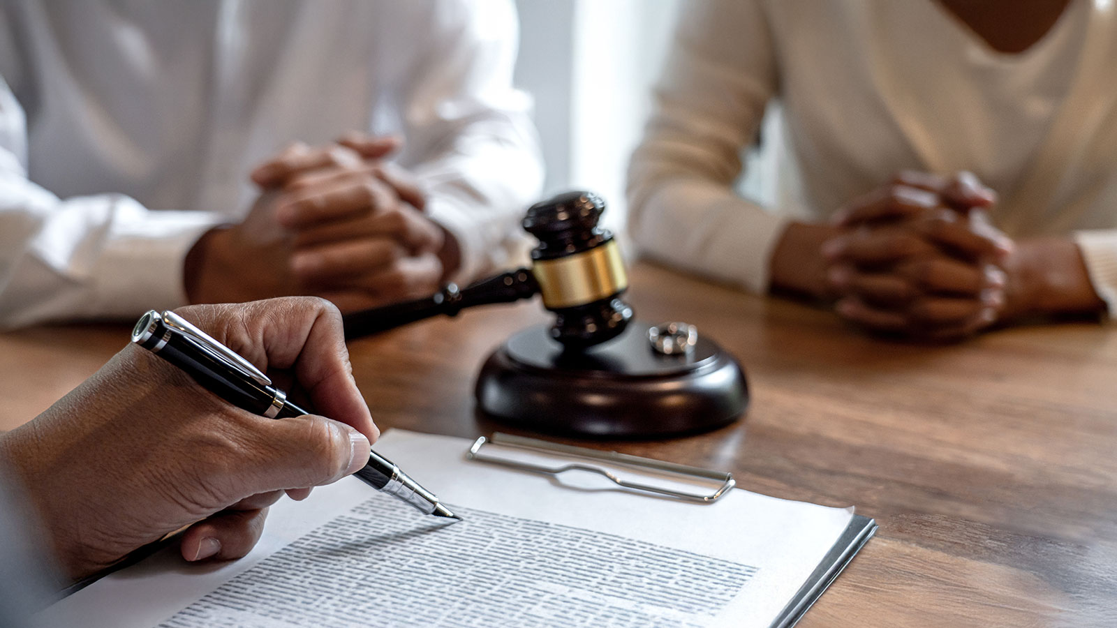 Unhappy divorce couple having conflict, husband and wife during divorce process with senior male lawyer