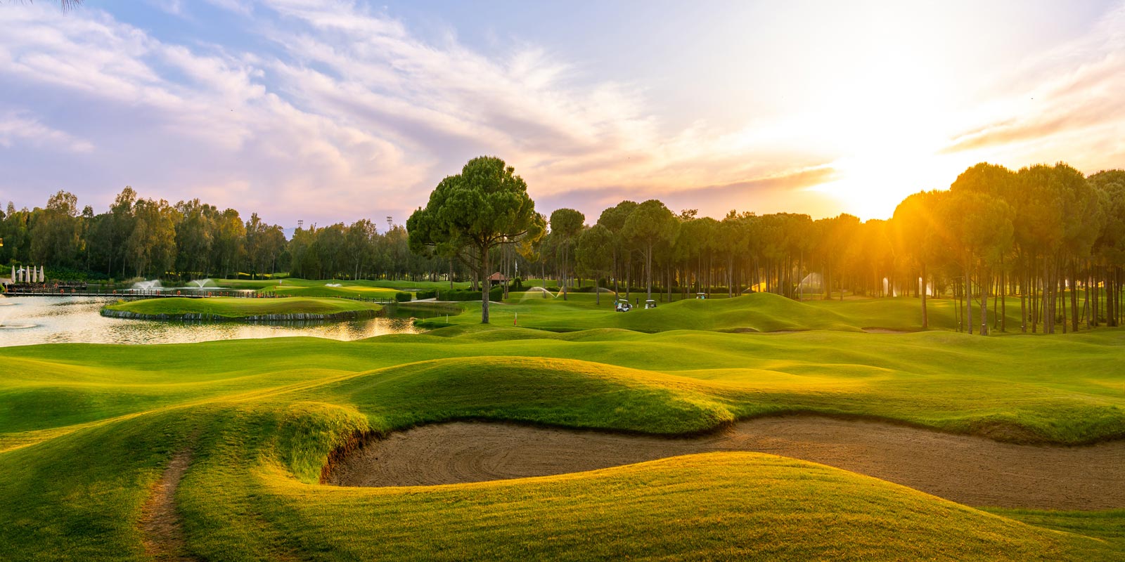 Golf course at sunset with beautiful sky and sand trap