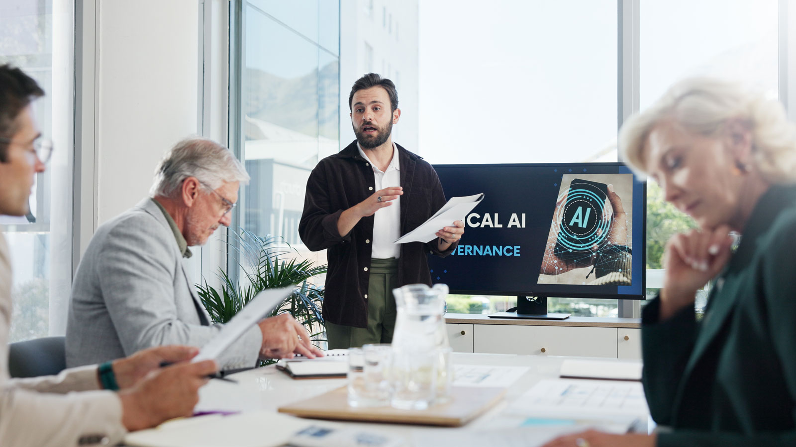 Presentation, paperwork and businessman in office with team for AI governance system