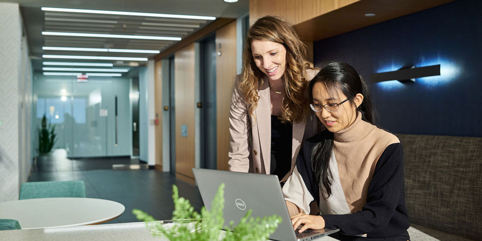 Weaver employees collaborating on a laptop