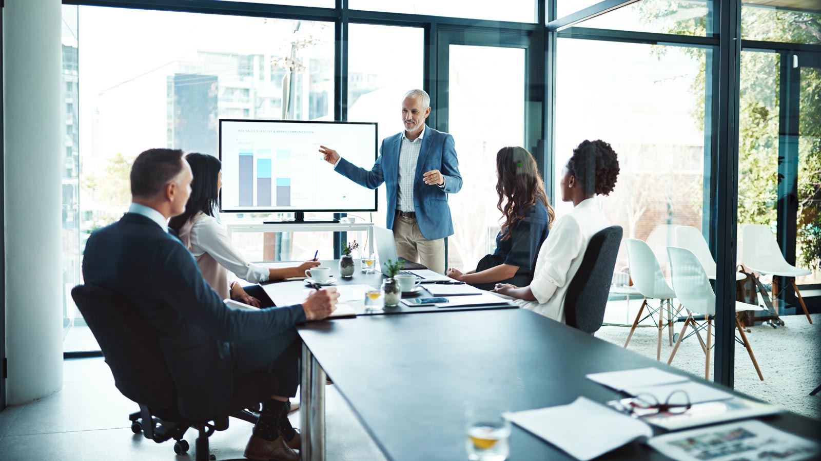 Business, charts and man with presentation, office and conversation for project, profit growth and meeting