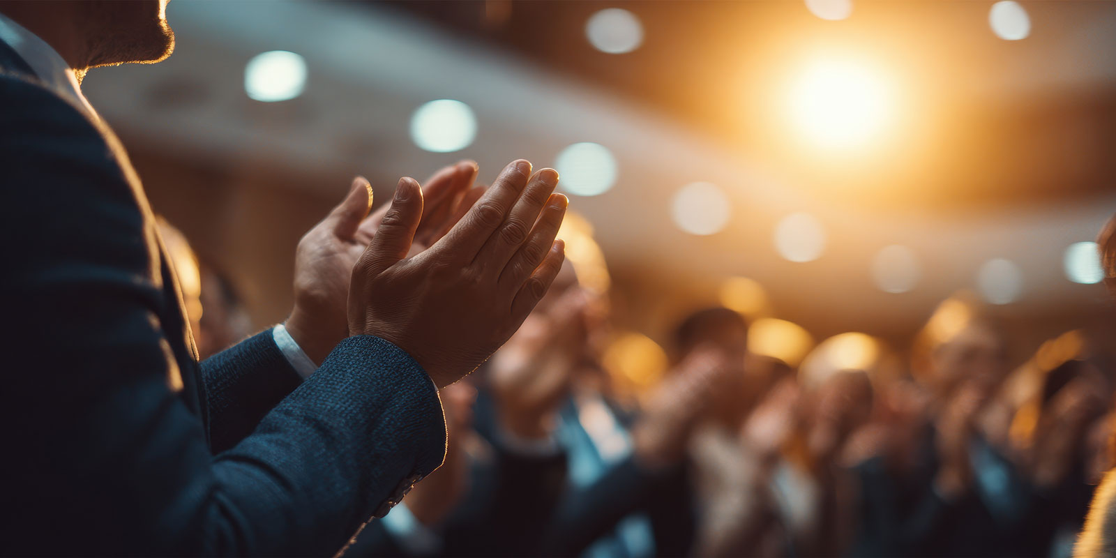 Audience applauding at a successful seminar about profit growth and achievements