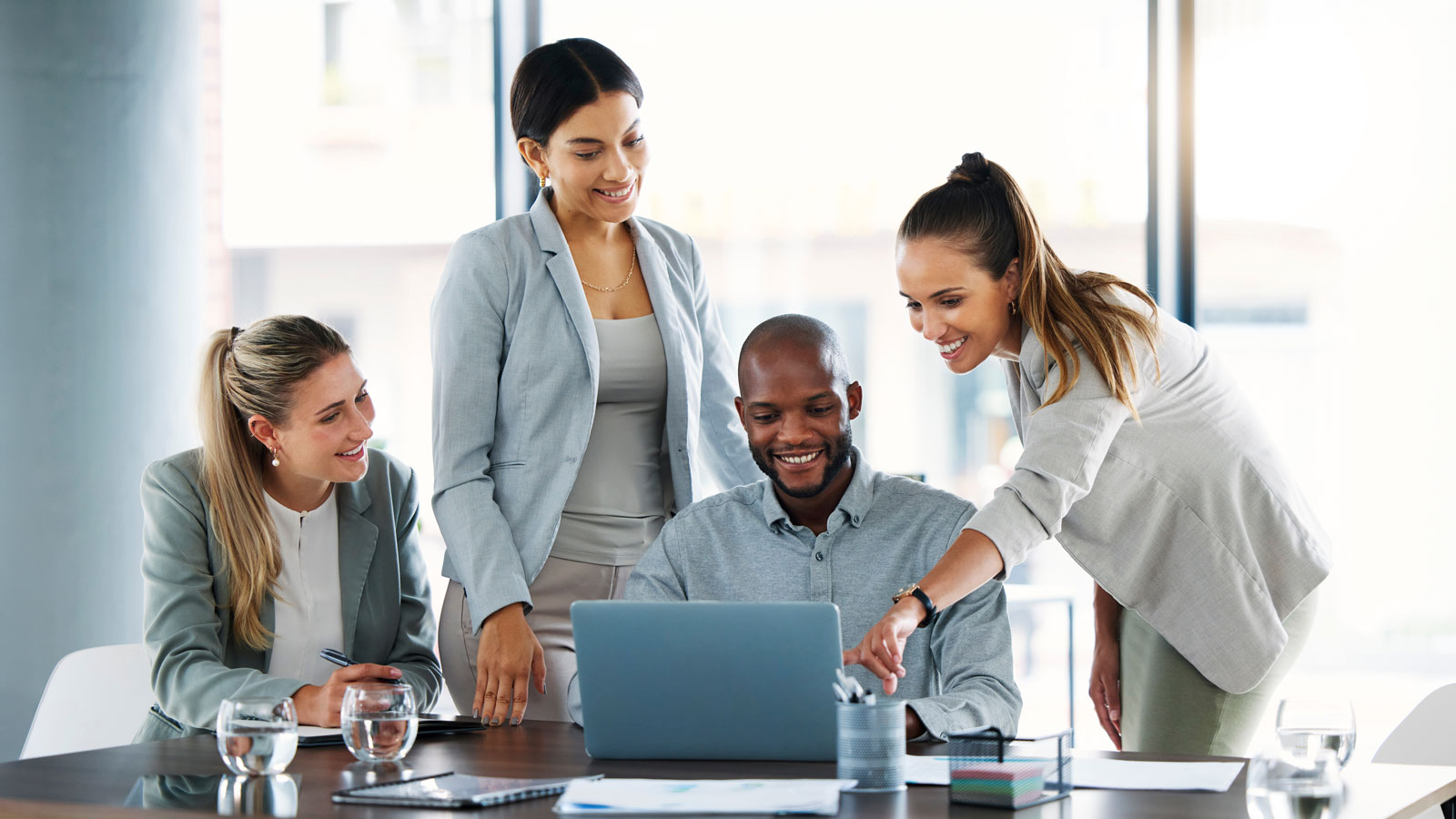 Business people, laptop and meeting for team idea, strategy or collaboration on group project at the office