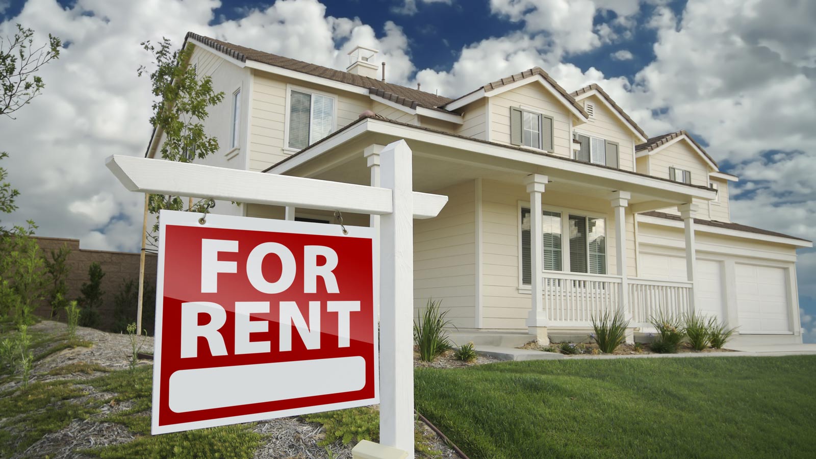 For Rent Real Estate Sign in Front of House