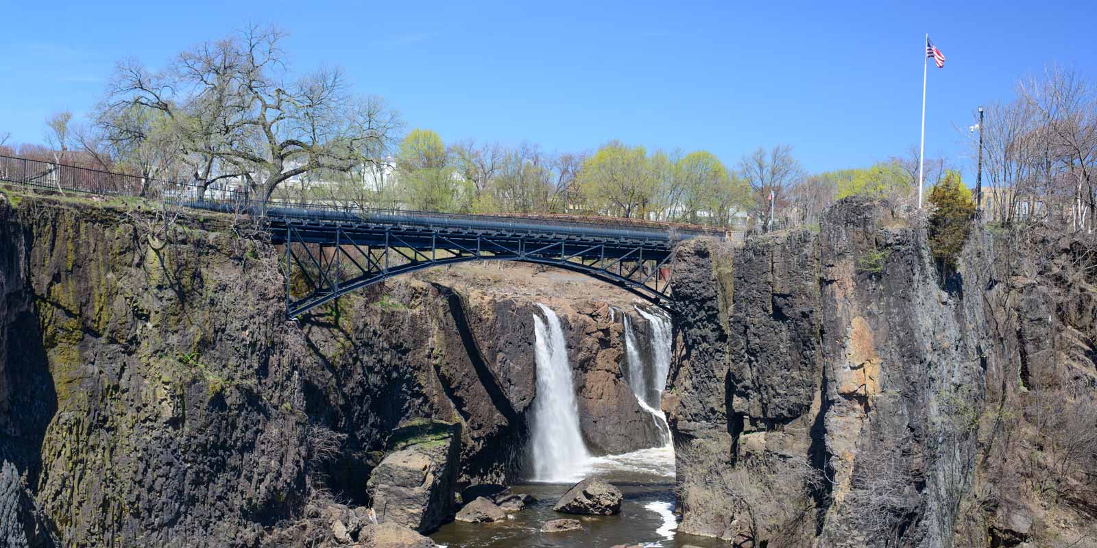 The great falls on the Passaic river in Paterson NJ with the pedestrian footbridge