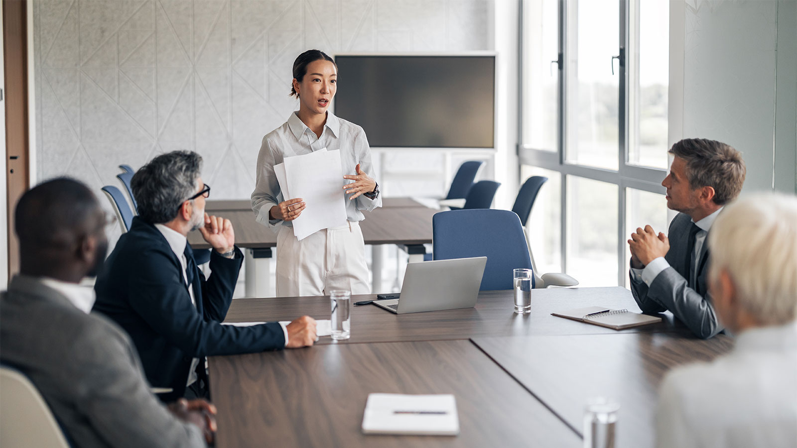 usinesswoman leading presentation during corporate board meeting