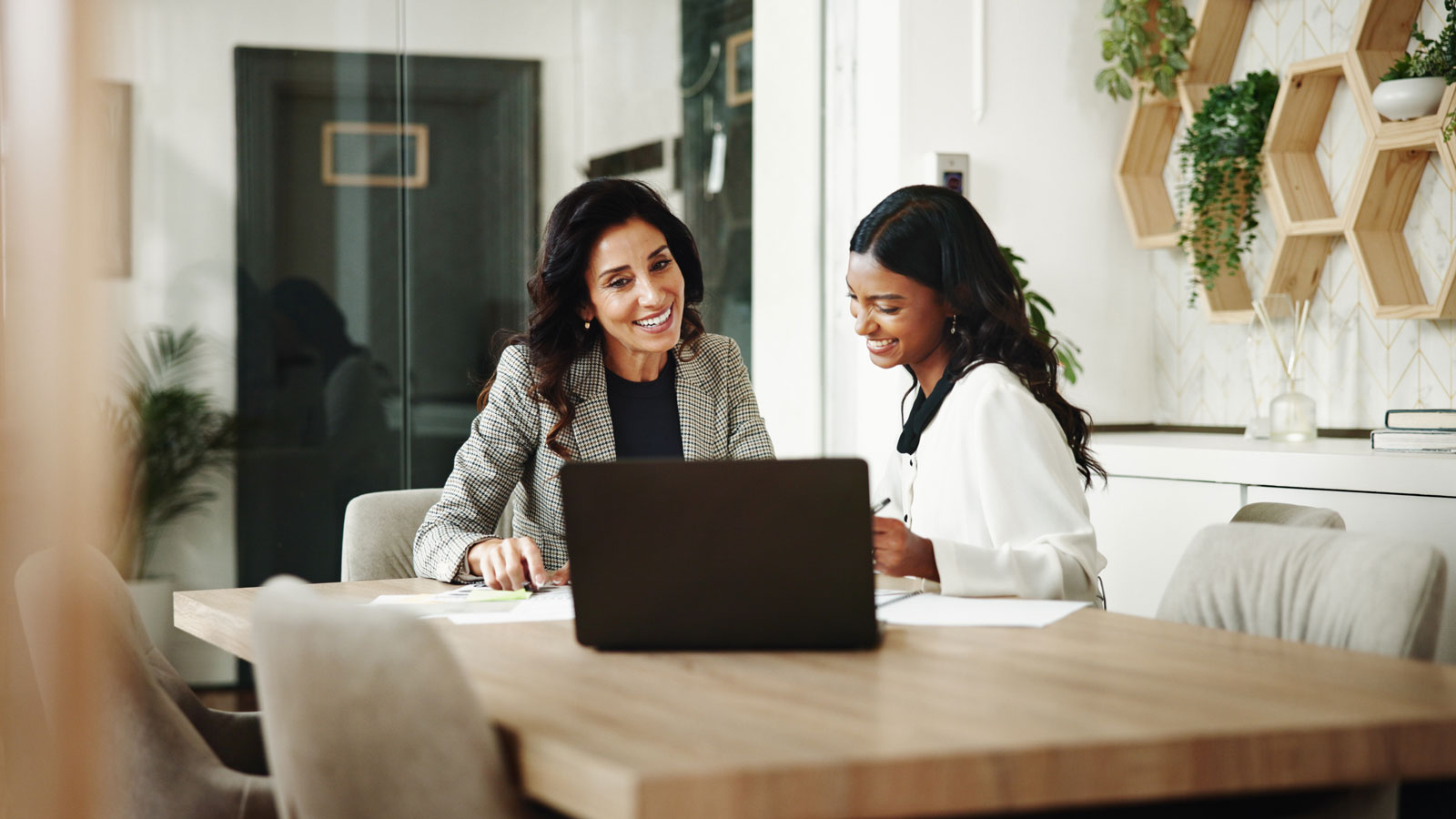 Meeting, women and business people with laptop in office